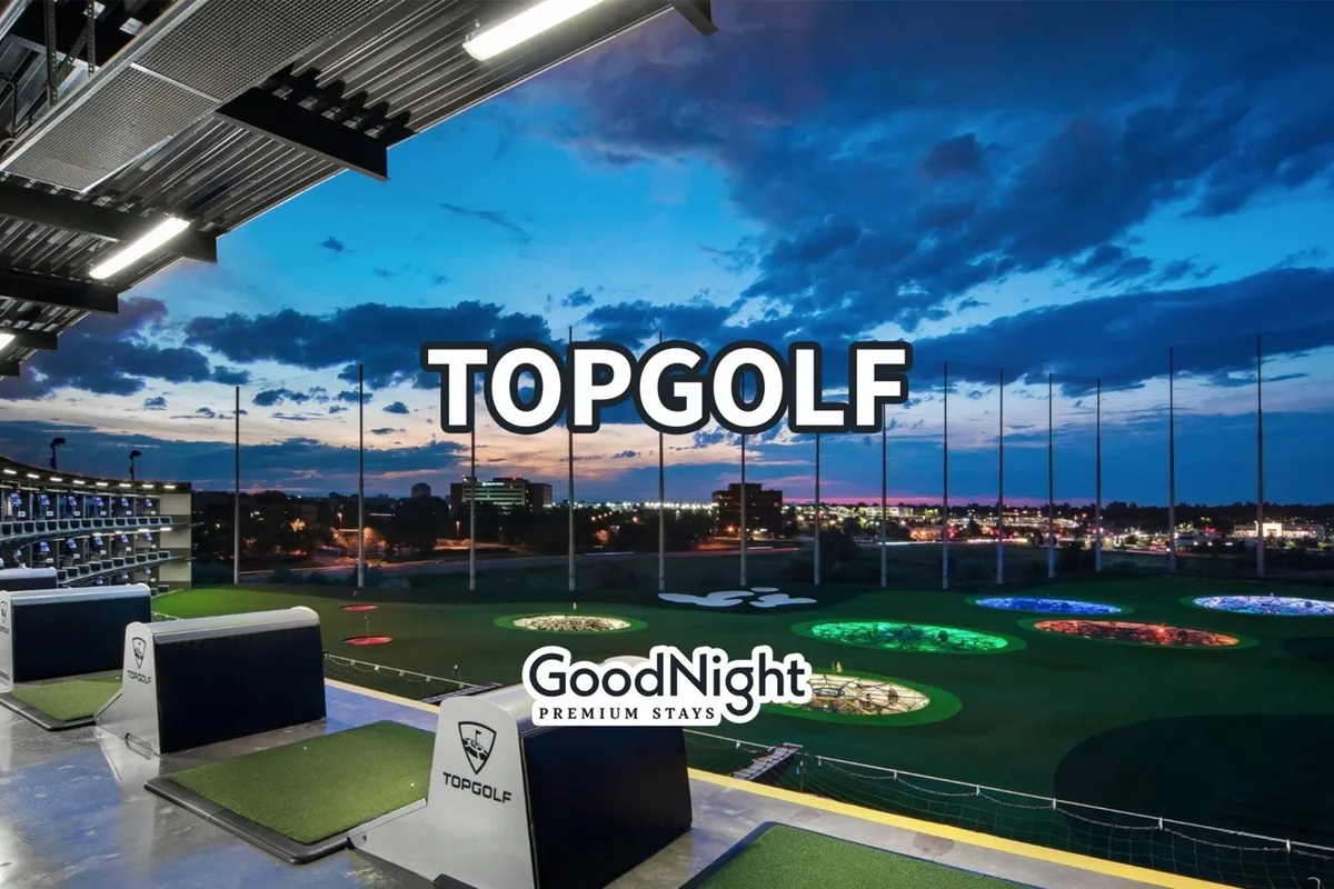 This vibrant image shows an open-air Topgolf venue, with colorful golfing targets and the Nashville skyline in the background. Guests are engaged in golfing and socializing, suggesting a lively atmosphere perfect for family bonding and friendly competition.